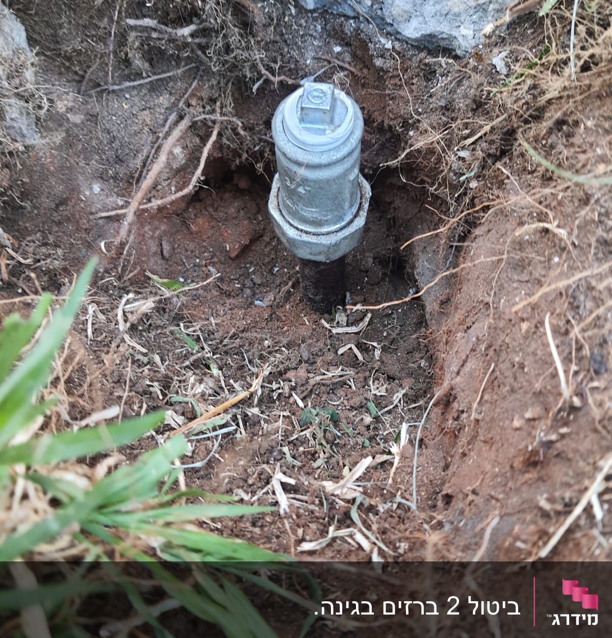 שסתום מתכת חשוף באדמה עם צינור